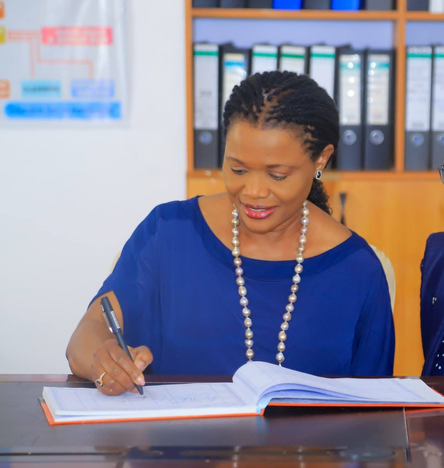 Nnaabagereka Sylvia Nagginda registers to the visitors book during a visit to Abasaakaate at the Ekisaakaate 2026 at Hormisdallen School in Gayaza.